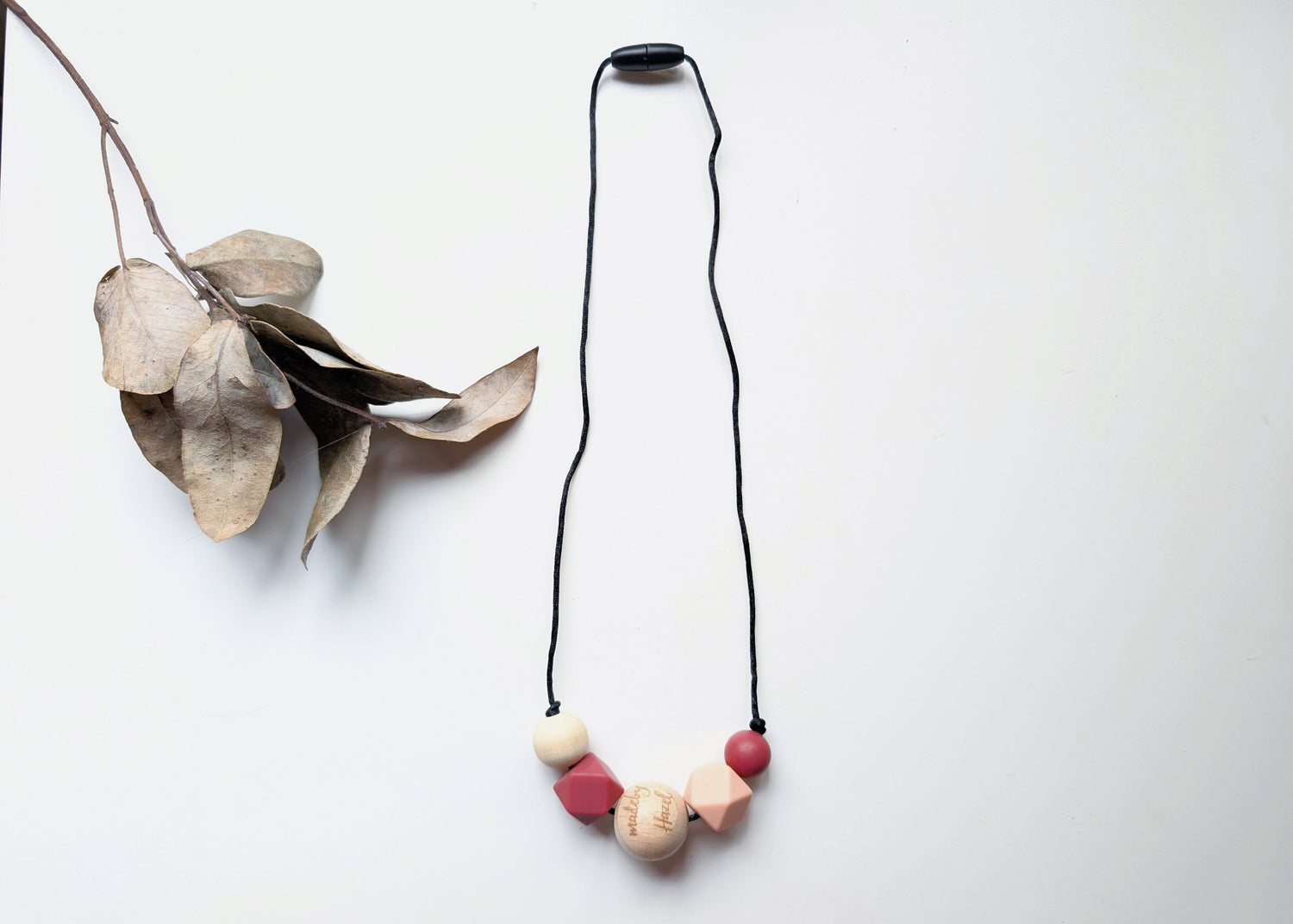 Safe sensory necklace in mauve and peach tones