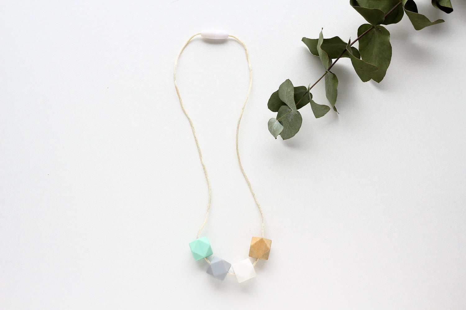 Mint flatlay - Fiddle Teething Activity Necklace natural wood & silicone!